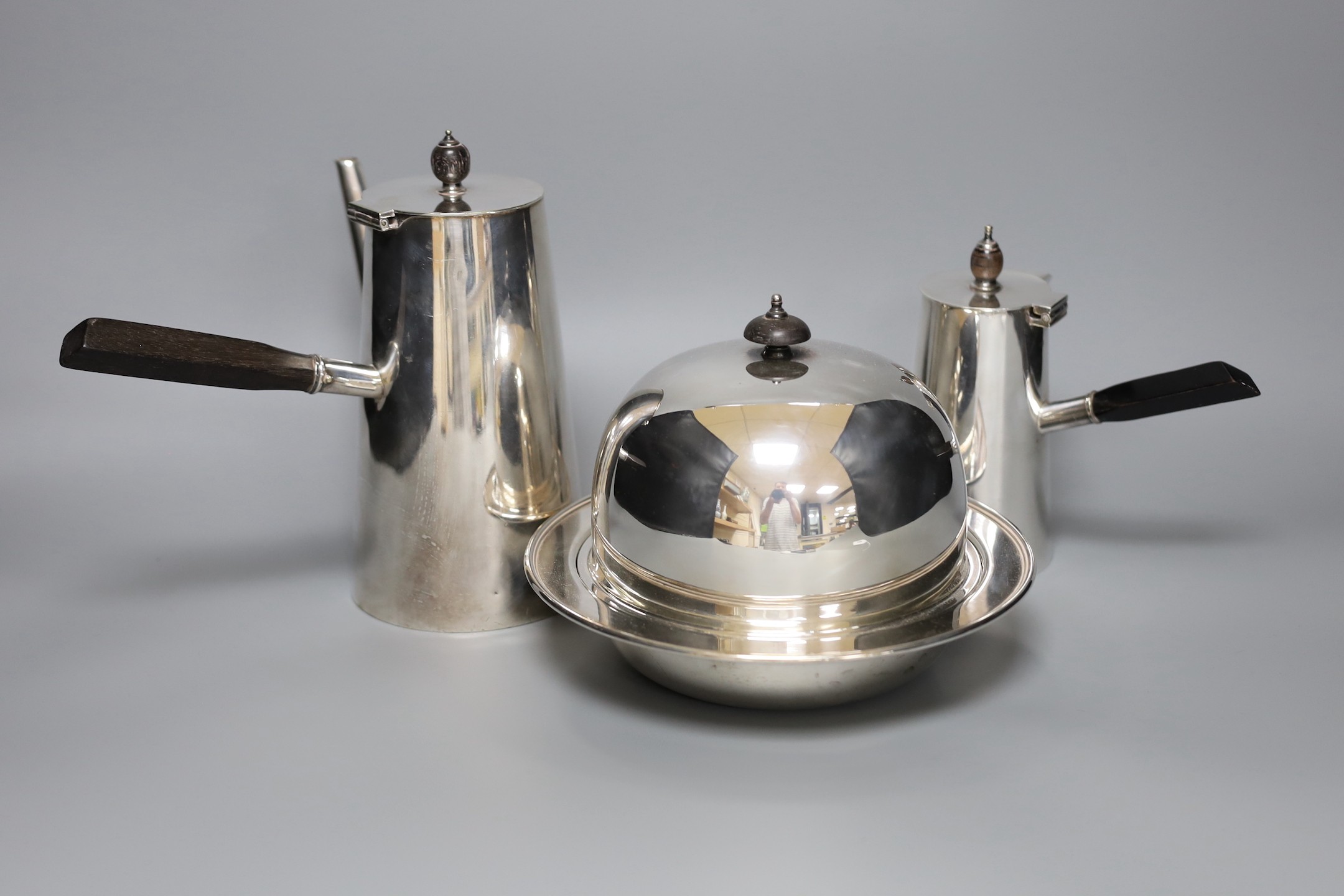 Two silver plated cafe au lait pots one with double wall interior and a muffin dish